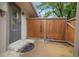 A private patio area featuring a wooden fence and convenient access to the home's entrance at 1765 S Kline Way, Lakewood, CO 80232