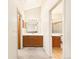 Vanity in hall bathroom with wood cabinets and tile floors, between bedroom and bathroom at 8777 W Cornell Ave # 2, Lakewood, CO 80227