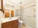 Clean bathroom featuring a vanity with light wood cabinets and glass-enclosed shower at 8777 W Cornell Ave # 2, Lakewood, CO 80227