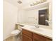 Clean bathroom with a large mirror, wooden vanity, and a toilet in a well-lit space at 8777 W Cornell Ave # 2, Lakewood, CO 80227