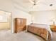 Bedroom featuring neutral walls, fan, and wooden furnishings, offering a comfortable retreat at 8777 W Cornell Ave # 2, Lakewood, CO 80227