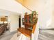 Welcoming foyer with display cabinet, open staircase, and convenient access to the kitchen at 8777 W Cornell Ave # 2, Lakewood, CO 80227