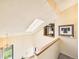 Bright foyer showcasing a skylight, modern lighting, and a glimpse of a charming wooden railing at 8777 W Cornell Ave # 2, Lakewood, CO 80227