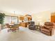 Open living area with views to kitchen, cozy seating, and dining area near sliding glass doors at 8777 W Cornell Ave # 2, Lakewood, CO 80227