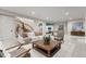 Finished basement with comfortable seating, a foosball table and a large TV at 6561 S Harlan Ct, Littleton, CO 80123