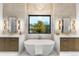 Elegant bathroom with a freestanding tub and dual vanities at 6561 S Harlan Ct, Littleton, CO 80123