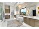 Luxurious bathroom with soaking tub, double vanity, and walk-in shower at 6561 S Harlan Ct, Littleton, CO 80123