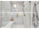 Spa-like shower with a built-in seat and glass enclosure at 6561 S Harlan Ct, Littleton, CO 80123