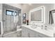 Clean bathroom with a walk-in shower and updated vanity at 6561 S Harlan Ct, Littleton, CO 80123