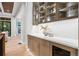 Well-appointed butler's pantry with glass-front cabinetry and quartz countertops at 6561 S Harlan Ct, Littleton, CO 80123