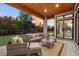 Relaxing covered patio with comfortable seating and a view of the backyard at 6561 S Harlan Ct, Littleton, CO 80123
