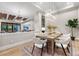 Bright dining room features a modern chandelier and seating for six at 6561 S Harlan Ct, Littleton, CO 80123