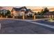 Luxury home with a gated entry and beautiful landscaping at dusk at 6561 S Harlan Ct, Littleton, CO 80123