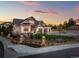 Luxury home with a gated entry and beautiful landscaping at dusk at 6561 S Harlan Ct, Littleton, CO 80123