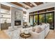 Spacious living area with fireplace, hardwood floors, and access to backyard at 6561 S Harlan Ct, Littleton, CO 80123