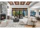 Bright living room features a cozy fireplace and large windows with backyard access at 6561 S Harlan Ct, Littleton, CO 80123