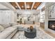 Light-filled living room with sectional sofa, fireplace, and high ceilings at 6561 S Harlan Ct, Littleton, CO 80123