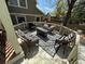 Inviting outdoor deck area with wicker seating, a patterned rug and a cozy gas fire pit at 11245 San Joaquin Rdg, Littleton, CO 80127