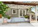 Relaxing back patio with a pergola, outdoor seating, a swing and a decorative patterned rug at 11245 San Joaquin Rdg, Littleton, CO 80127