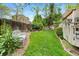 Lush backyard featuring a well-maintained lawn and mature trees at 11245 San Joaquin Rdg, Littleton, CO 80127