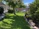 Beautifully landscaped backyard with lush green grass, seating area and a charming playhouse at 11245 San Joaquin Rdg, Littleton, CO 80127