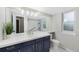 Bathroom with a large mirror, blue vanity, and white countertops at 11245 San Joaquin Rdg, Littleton, CO 80127