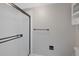 Bathroom with frosted glass door shower, white tile, and black fixtures at 11245 San Joaquin Rdg, Littleton, CO 80127