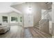 Bright foyer featuring high ceilings, gray-tone floors, staircase, and natural light at 11245 San Joaquin Rdg, Littleton, CO 80127