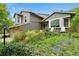 Well-maintained home with mature landscaping, green lawn and seating area at 11245 San Joaquin Rdg, Littleton, CO 80127