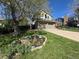 Well-manicured front yard featuring a two-story home, green lawn and a lovely flower bed at 11245 San Joaquin Rdg, Littleton, CO 80127
