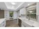 Bright kitchen showcasing a farmhouse sink, subway tile backsplash, and natural light from large windows at 11245 San Joaquin Rdg, Littleton, CO 80127