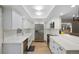 Modern kitchen featuring stainless steel appliances, sleek white cabinets, and quartz countertops at 11245 San Joaquin Rdg, Littleton, CO 80127