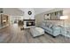 Open-concept living room featuring a fireplace, hardwood floors, and view to kitchen at 11245 San Joaquin Rdg, Littleton, CO 80127