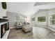 Cozy living room with fireplace, hardwood floors, neutral decor, and large windows at 11245 San Joaquin Rdg, Littleton, CO 80127