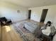 Bright bedroom features wood-look flooring, with a comfy chair, and two closet doors at 17361 E Mansfield Ave # 521R, Aurora, CO 80013