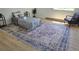 Sunlit bedroom has wood-look floors and a decorative rug under the bed with ample space at 17361 E Mansfield Ave # 521R, Aurora, CO 80013