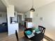 Modern dining area adjacent to the kitchen, featuring bright lighting and simple decor at 17361 E Mansfield Ave # 521R, Aurora, CO 80013