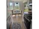 Bright kitchen nook features a table set for two and large windows overlooking the greenery at 17361 E Mansfield Ave # 521R, Aurora, CO 80013