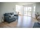 Bright living room with modern flooring and a sliding glass door to the balcony at 17361 E Mansfield Ave # 521R, Aurora, CO 80013
