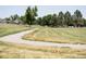 Lush park with walking path, mature trees, and open green space, offering a scenic and recreational area at 17361 E Mansfield Ave # 521R, Aurora, CO 80013