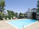 A clear blue community pool is surrounded by lounge chairs, offering a refreshing escape for residents at 17361 E Mansfield Ave # 521R, Aurora, CO 80013