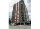 Brick high-rise building with balconies and ample parking at 550 E 12Th Ave # 1501, Denver, CO 80203