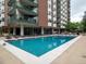 Inviting outdoor pool with lounge chairs and a surrounding patio at 550 E 12Th Ave # 1501, Denver, CO 80203