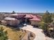 Sprawling estate with mature trees, a red metal roof, and ample parking at 24360 E Glasgow Dr, Aurora, CO 80016