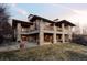 View of the home's backyard, featuring an upper and lower deck at 24360 E Glasgow Dr, Aurora, CO 80016