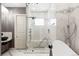 This modern bathroom boasts a sleek shower, a standalone tub, and gorgeous marble finishing at 24360 E Glasgow Dr, Aurora, CO 80016