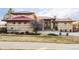 Stately home featuring stone accents, a red roof, and a well-manicured front yard at 24360 E Glasgow Dr, Aurora, CO 80016