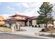 Elegant home with a red metal roof, manicured landscaping, and a circular driveway at 24360 E Glasgow Dr, Aurora, CO 80016