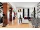 Bright living room with hardwood floors, white sofa, black accents, and shelving display at 24360 E Glasgow Dr, Aurora, CO 80016