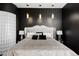 Modern bedroom with black walls, pendant lighting, and a tufted headboard for a luxurious feel at 24360 E Glasgow Dr, Aurora, CO 80016